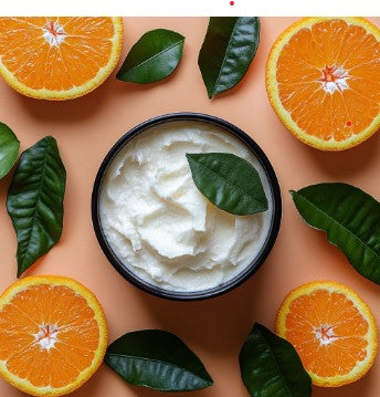 SWEET ORANGE - Citrus Body Butter in a black jar surrounded by fresh orange halves and green leaves, ideal for hydration and smooth skin care.